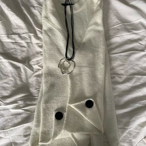 Oversized cream sweater with cuff accents